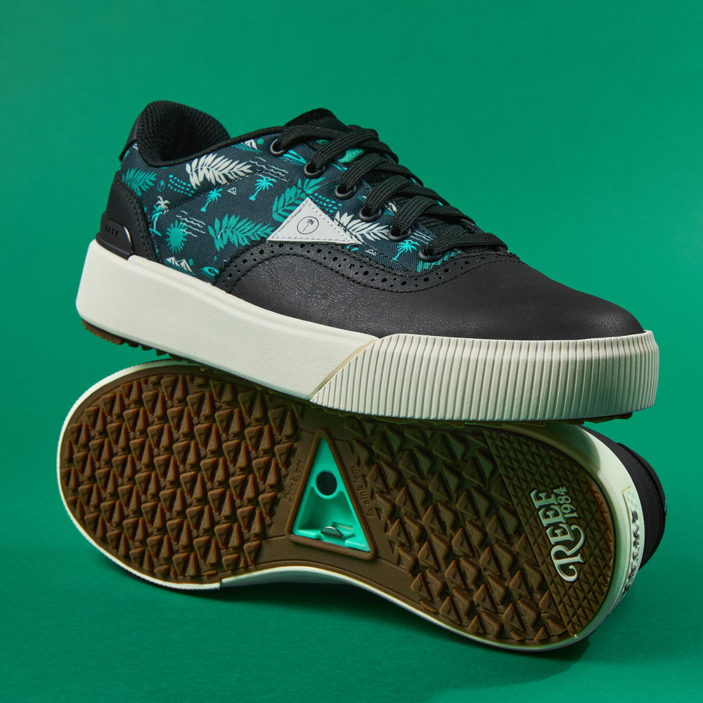 Onshore Pebble X Palm men's sneaker facing left with palm leaf pattern, cushioned sole, and textured outsole shown bottom up.