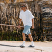 Phantom Slab black slides facing left on a beachside walk with cushioned comfort and arch support