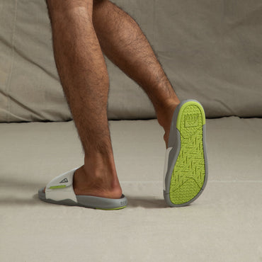 Phantom Slab men's slides facing backward showing lime green outsole with arch support and extra cushioning.