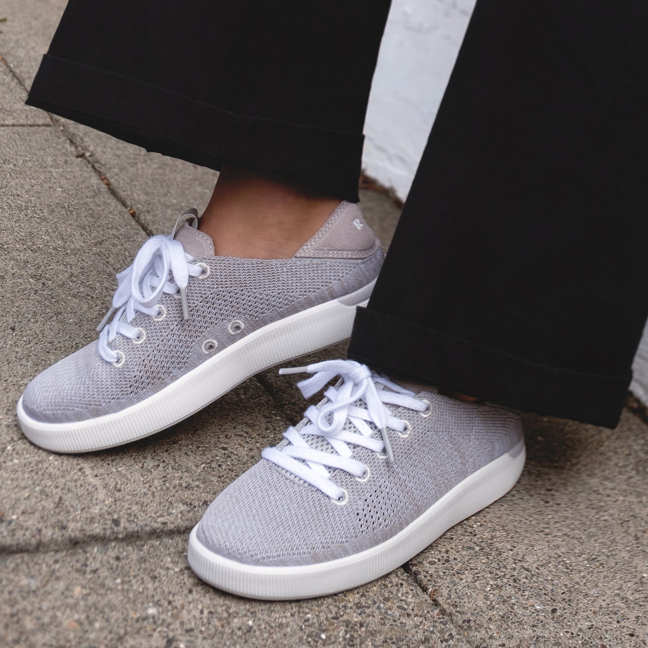 Reef Neptune women's gray sneakers facing left and right, breathable knit upper, cushioned sole, easy on and off design.