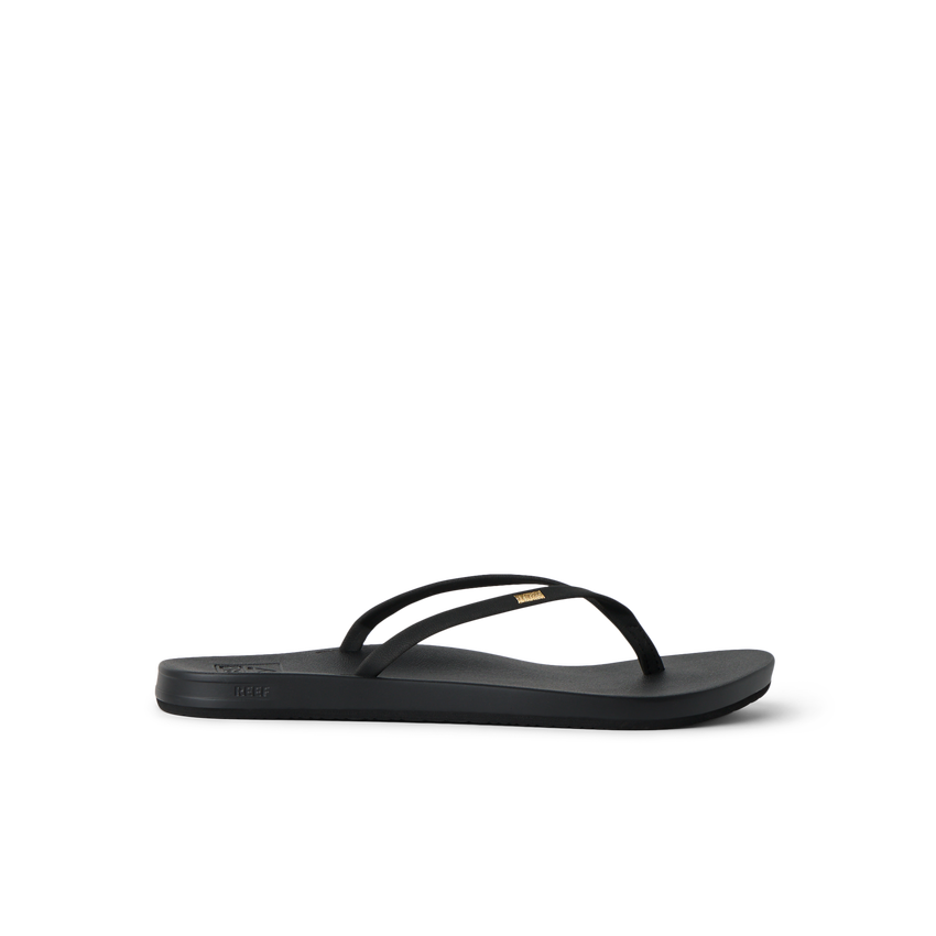 Cushion Slim black flip flop facing left, showing side profile with anatomical arch support and soft cushioning.