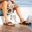 Man wearing brown reef santa ana sandals on a boat