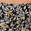 Close-up of the black floral fabric of the Sandy Romper showing gathered elastic waistband details for comfort and style.