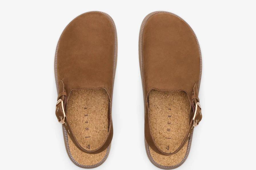 Top view of brown suede slingback sandals facing upward with cork footbeds and gold-tone buckle closures