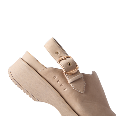 Vista Skye Rosa beige clog facing left with adjustable backstrap, cushioned sole, and reef branding on the side