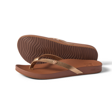 Vista Ivy women's sandals in bronze, side view with sole upward, surf-inspired comfort and anatomical arch support.