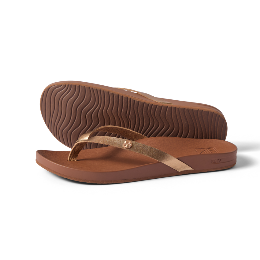 Vista Ivy women's sandals in bronze, side view with sole upward, surf-inspired comfort and anatomical arch support.