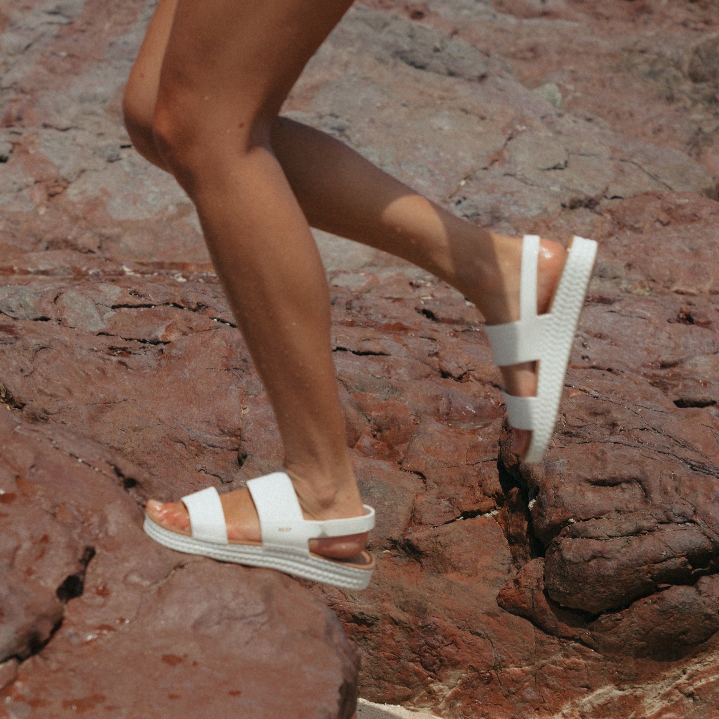 Reef Water Vista white tan sandals on woman’s foot facing right, highlighting cushioned arch support and water-friendly design.