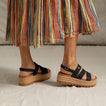 Pair of Water Vista Higher 2 sandals facing right, showing side view with black straps and tan platform sole, comfort focused design.