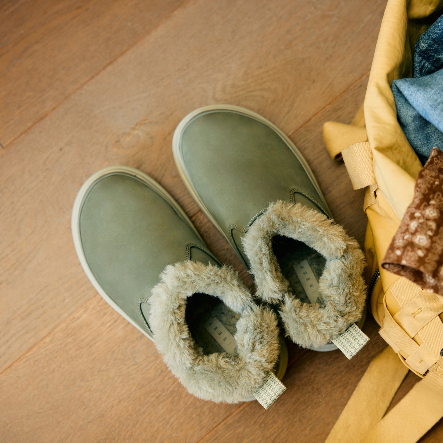 Weekend Olivia green nubuck shoes with plush faux fur lining, toes facing upper left in a top view close-up
