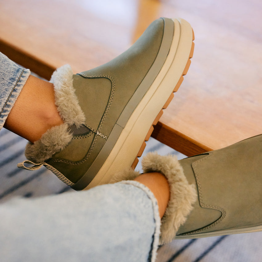 Weekend Olivia olive green boots facing right with plush faux fur lining and grippy lightweight soles