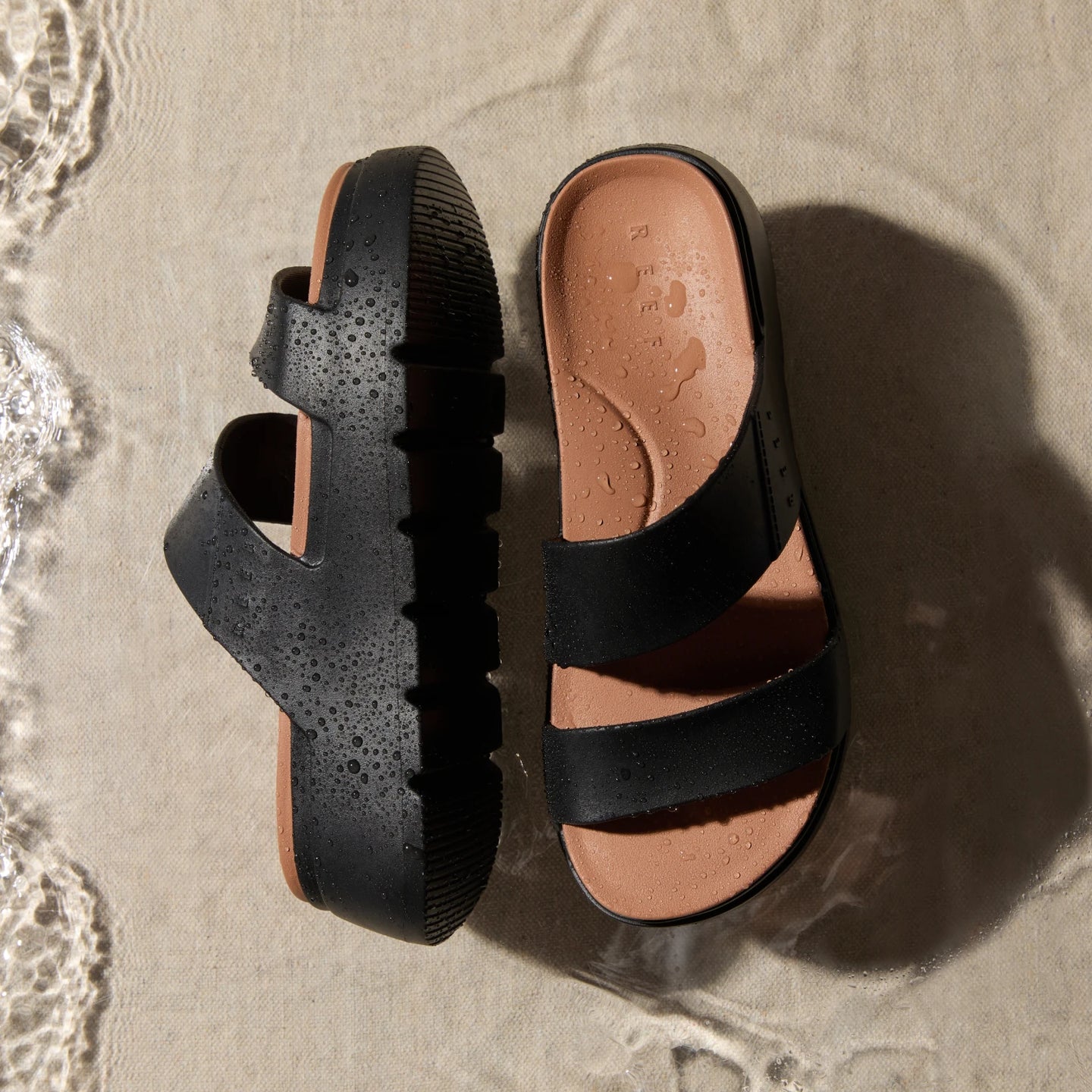 Top view of left and right Cali Solana sandals with dual asymmetrical straps, water-friendly and cushioned for beach comfort.