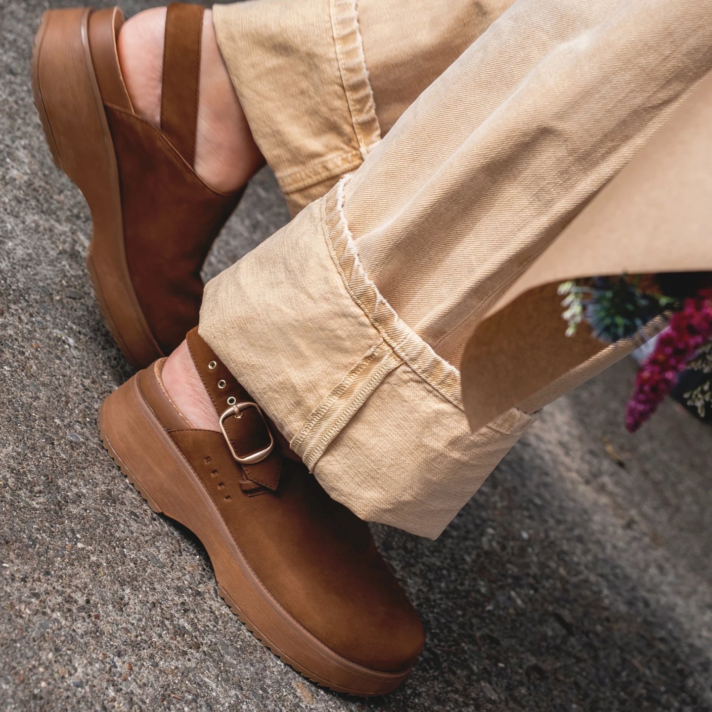 Vista Skye Rosa brown clogs facing left, showing side profile with adjustable backstrap and platform sole in casual outdoor setting.