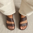 Top view of feet wearing brown Cali Solana sandals facing forward, highlighting cushioned comfort and stylish straps.